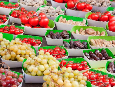 Display in a french market, bunch of grapes, cherry tomatoes