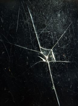 Cracked glass of cell phone display screen, vertical view