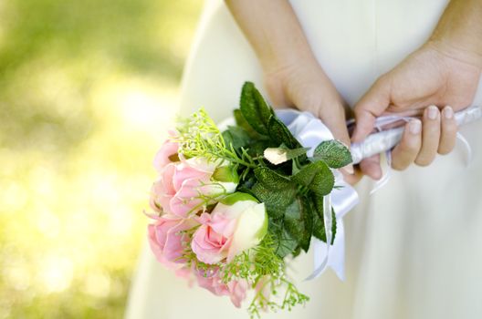 Bride holding her bouquet behind her back