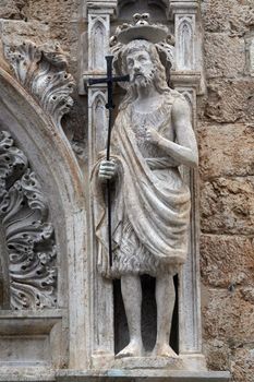 Statue of St. John the Baptist on the portal of the Franciscan church of the Friars Minor in Dubrovnik