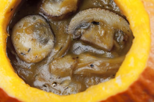 Creamy mushroom and pumpkin soup in a pumpkin bowl.