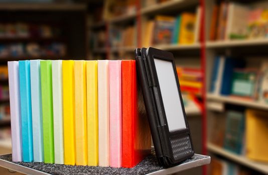 Row of colorful books with electronic book reader