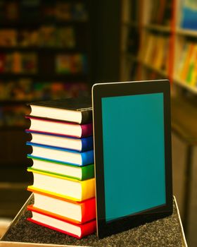 Stack of books with a tablet PC