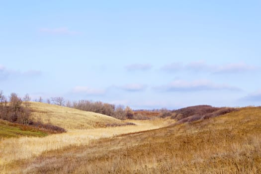 old river bed between two hills, grassy