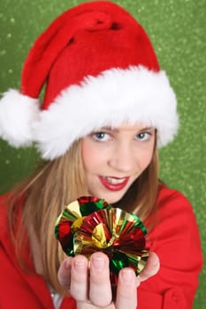 Teenager with red lips wearing a christmas hat. FOCUS ON DECORATIONS