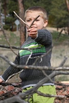 Little blond boy playing outside in the field