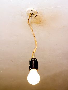 old dirty light bulb without canopy