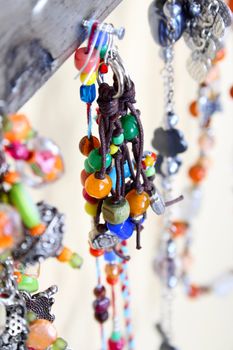 Beaded earrings hanging amongst other jewellery pieces