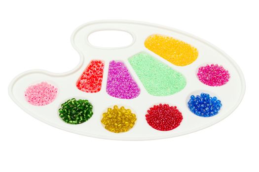 palette with bright colored beads of different shapes