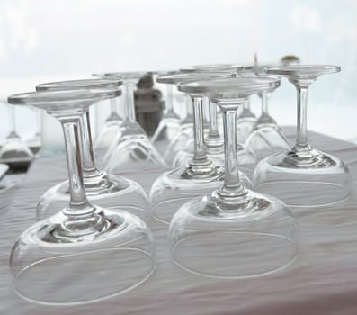 Rows of empty upside down wineglasses