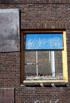 destroyed window on the old danaged wall