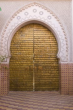 Entrance to a traditional riad in the shape of a key hole in Marrakesh, Morocco