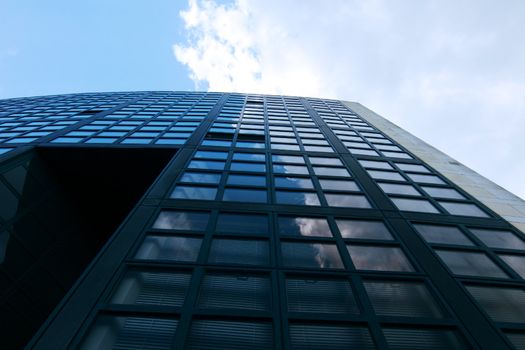 fragment of the modern glass building over blue sky