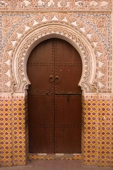 Entrance to a traditional riad in the shape of a key hole in Marrakesh, Morocco