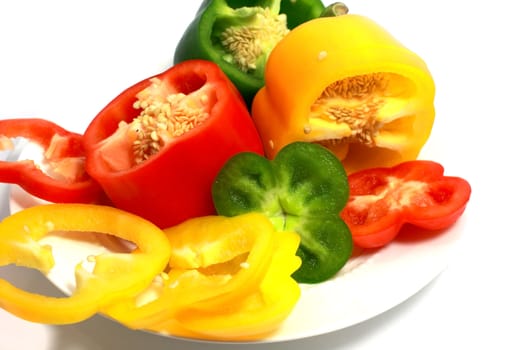 cut sweet red, yellow and green peppers isolated