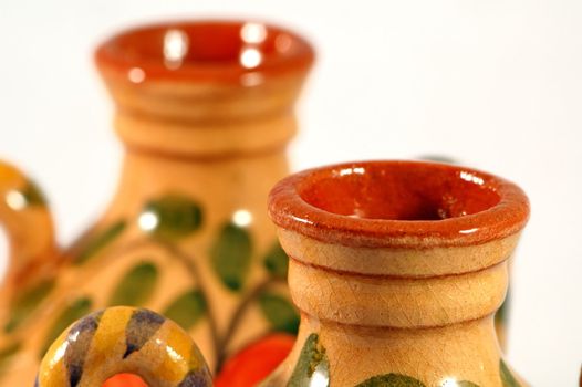 Ceramic pot with flower painting over white