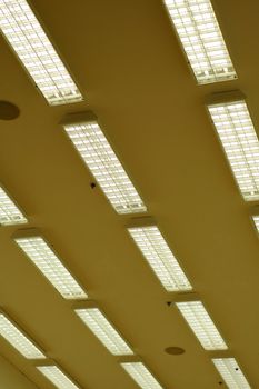 Rows of fluorescent lamps of office ceiling