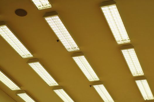 Rows of fluorescent lamps of office ceiling