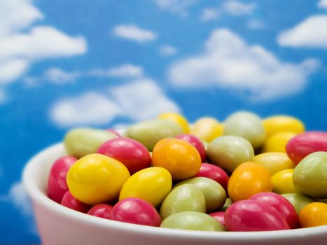 Colorful candies over a blue sky