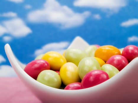 Colorful candies over a blue sky