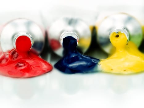 Multicolored paint tubes on a white background