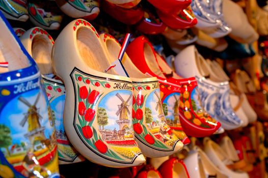 Decorated dutch clogs with winmill painting hanging on the wall