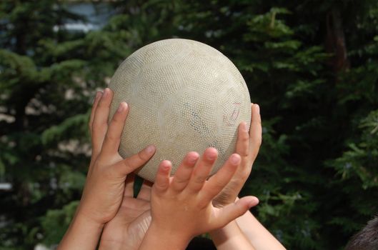 hands of boys holding ball