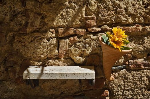 Yellow flowers on brick wall with copy space