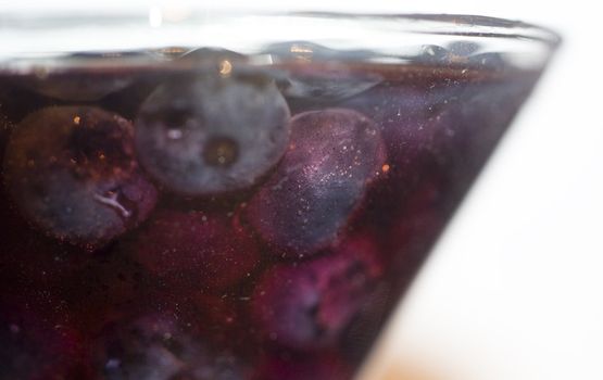 close up shot of blueberries and alcohoL