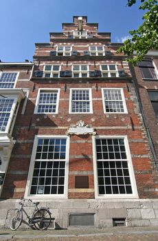 Historic Dutch house with 'step' gable and bicycle parked in front