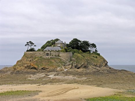 Anse du Guesclin, Pointe du Grouin with a castle is on an little island in Brittany, North France