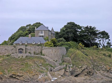 Anse du Guesclin, Pointe du Grouin with a castle is on an little island in Brittany, North France