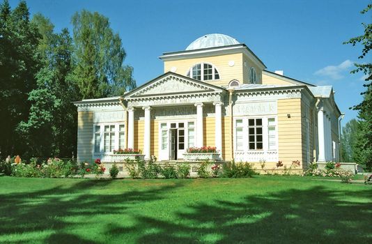 Wooden building in classical style in summer day