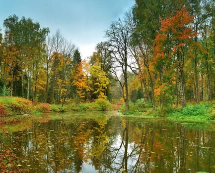 Panorama of autumn park with the pond