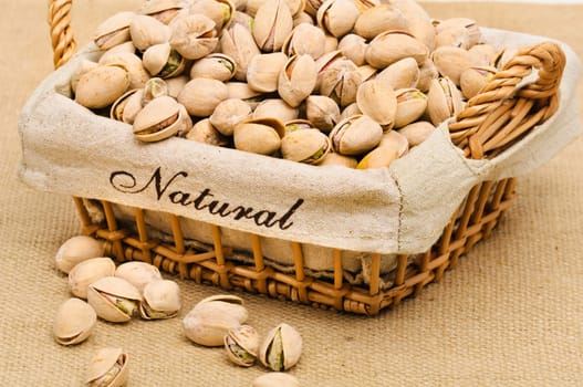 Close-up of pistachio nuts in the basket.
