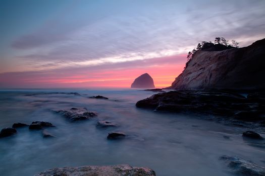 Colorful sunset in Oregon at Cape Kiwanda with long exposure