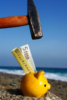 closev up of yellow piggybank with hammer