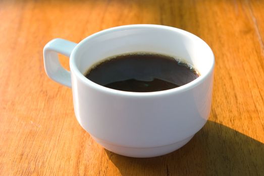 Hot coffee cup in the morning on wooden table