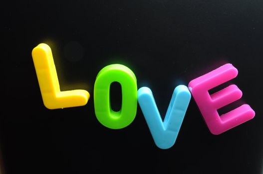 Word love formed by magnetic letters of different colours