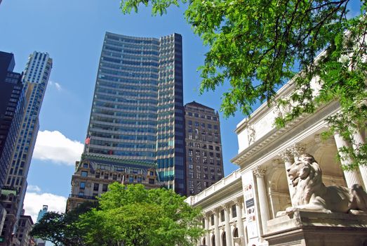 Skyscapers  and the entrance to the main branch of the new york city public library.
