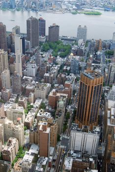 Aerial view of midtown Manhattan looking east from the 102nd floor observation deck of the empire state building.