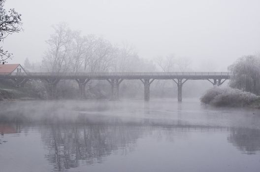 Bridge photographed on foggy day.