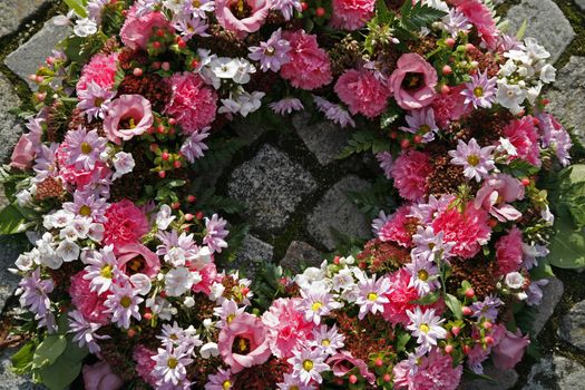 Pink garland on grave.