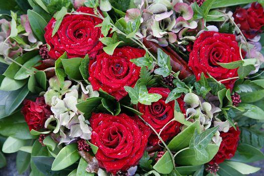 Decoration with red roses and hydrangea found on grave.