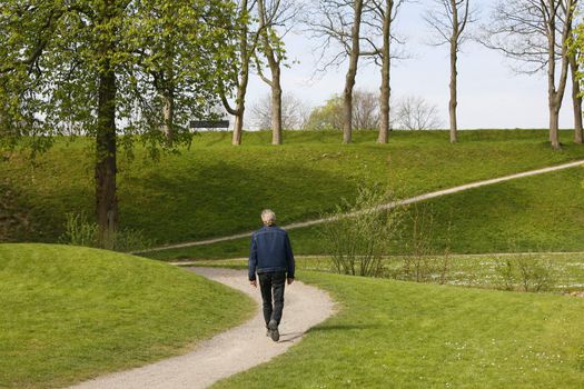 Lonely man walking around the embankments of Nyborg - Denmark.