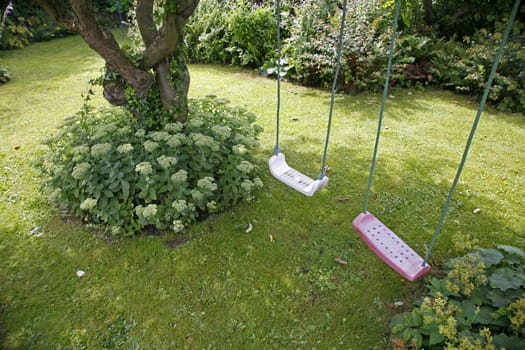 Old Danish country garden with Sedum Telephium Herbstfreude and swings for the children.