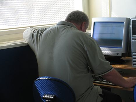 Mature man fighting his PC.