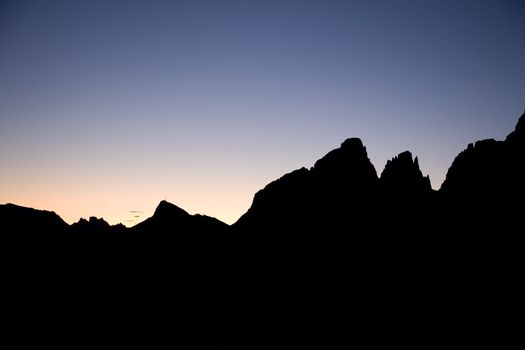 Peaks of the Dolomites in sunset seen from the mountain pass Pordoi - Italy.