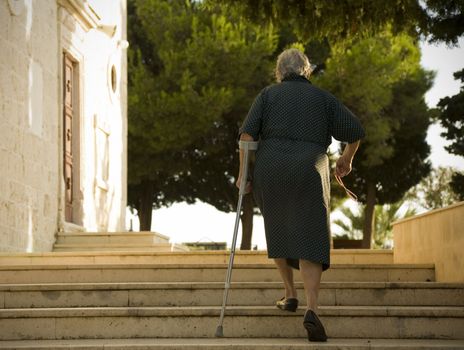 Elderly female on her way to evening Mass - Primosten, Croatia.