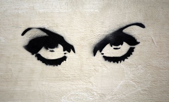 Graffiti eyes on Italian wall.